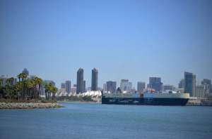 A cargo ship cruises through the heart of the bay in San Diego.
